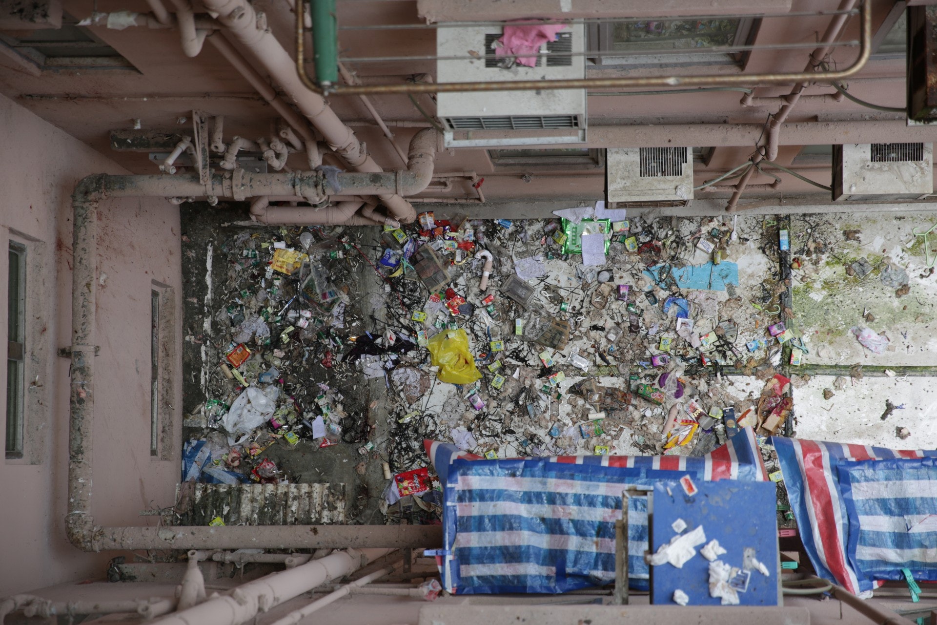 「小白」倒臥平台,該處滿佈垃圾及雜物。(黃偉民攝)