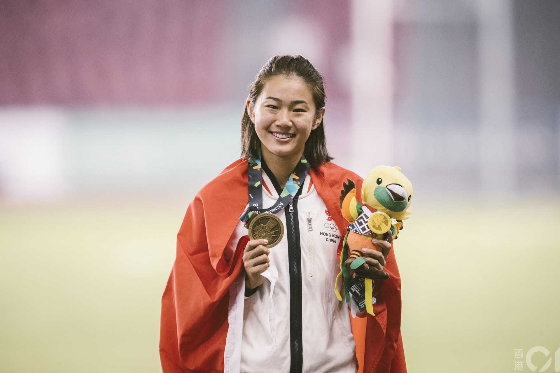掛上雅加達亞運女子100米跨欄銅牌，呂麗瑤的笑容，背後滿是甜酸苦辣。（鄭子峰攝）