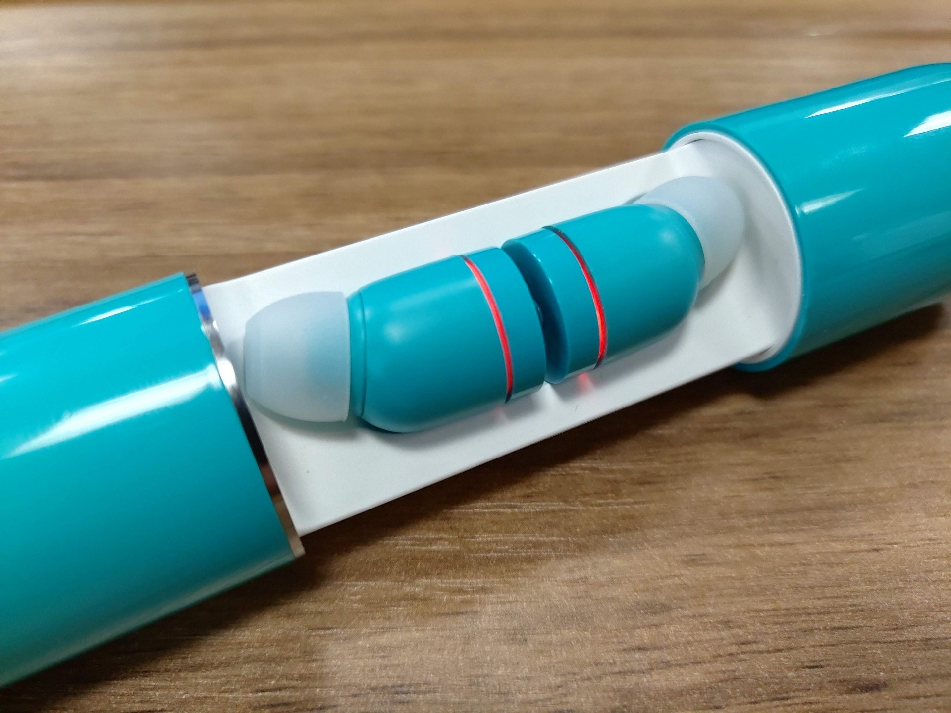 當耳機快將沒電時,耳機上的 LED 燈會每 5 秒跳動 2 次,將之放入電池盒時,會亮著慢閃紅燈,表示正在充電(蔡浩騰 攝) 當耳機快將沒電時,耳機上的 LED 燈會每 5 秒跳動 2 次,將之放入電池盒時,會亮著慢閃紅燈,表示正在充電(蔡浩騰 攝)