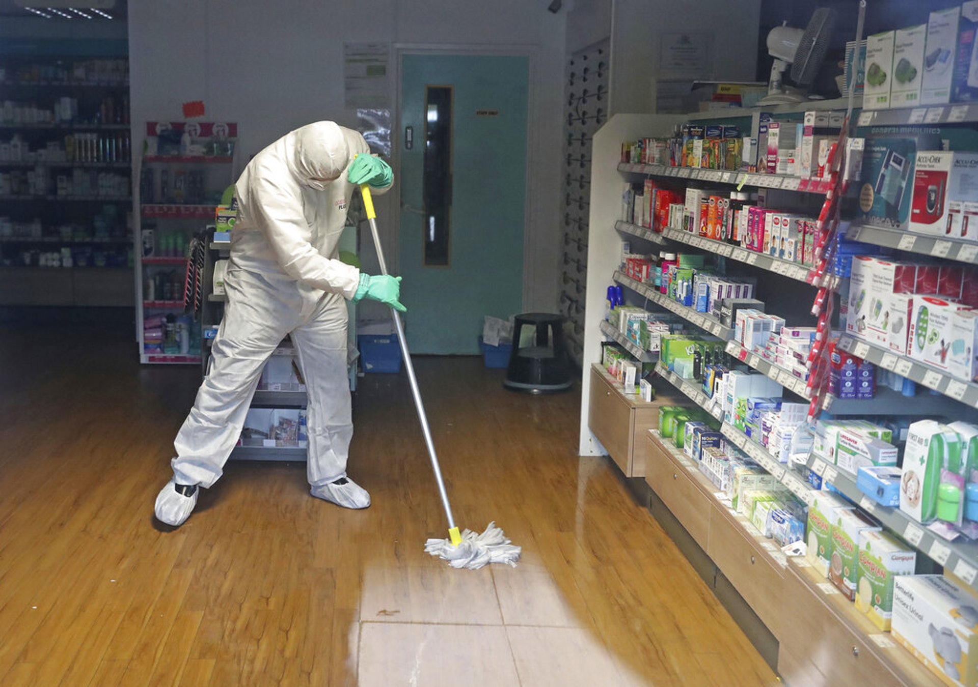 一名身穿防護服的男子在布賴頓一間醫療中心進行清潔工作。（AP）