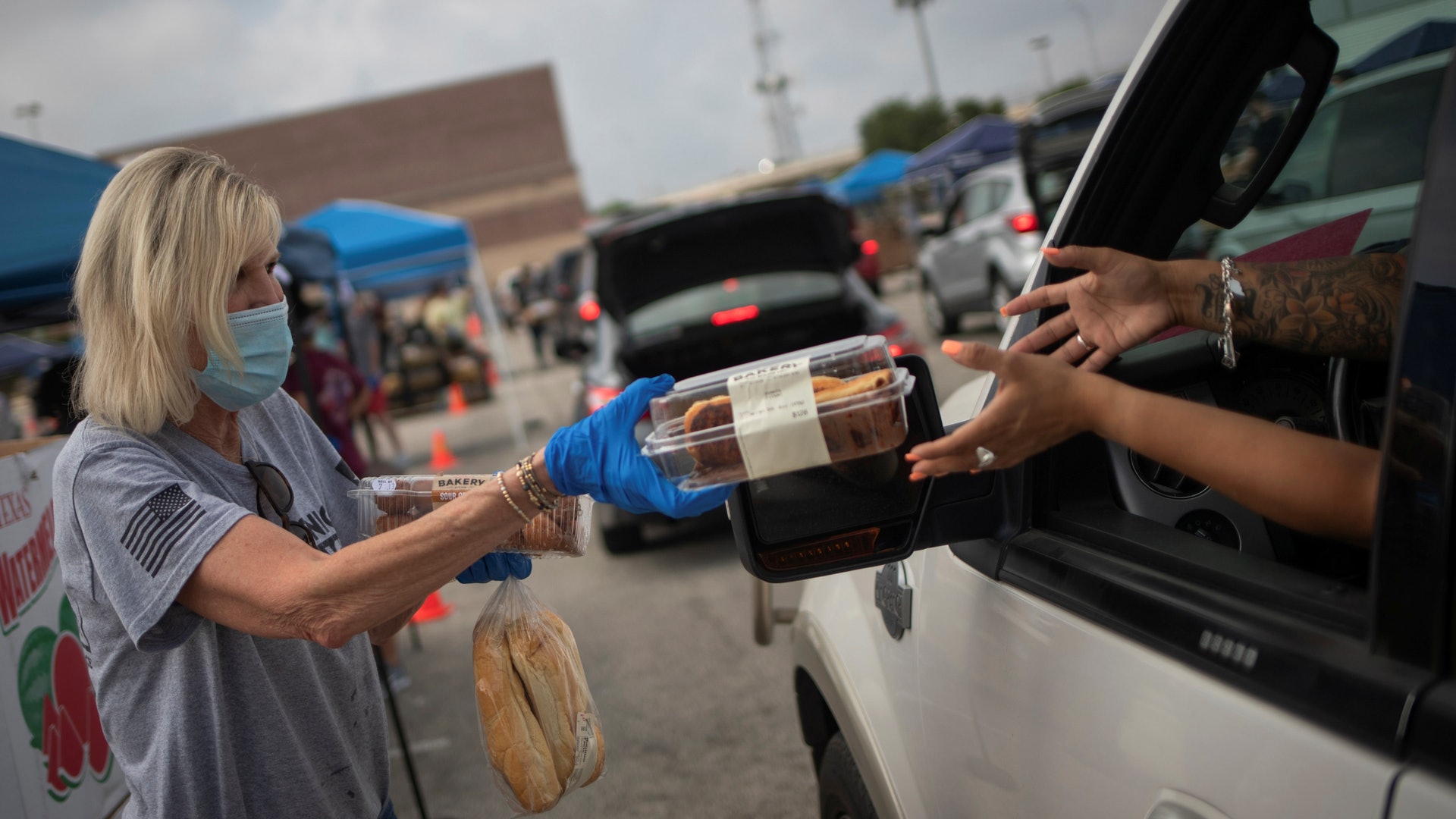 在美國德克薩斯州,新型冠狀病毒肺炎疫情嚴重。圖為7月17日德克薩斯州食物銀行義工向民眾分發食物。(Reuters) 在美國德克薩斯州,新型冠狀病毒肺炎疫情嚴重。圖為7月17日德克薩斯州食物銀行義工向民眾分發食物。(Reuters)
