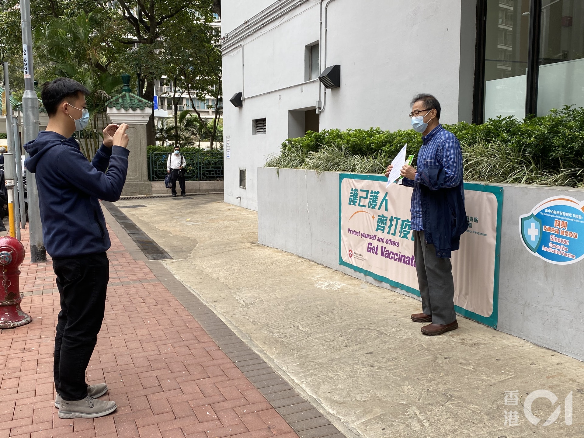 油尖旺區議員孔昭華在打針後,即帶同針卡在地下拍照打卡。(麥凱茵攝) 油尖旺區議員孔昭華在打針後,即帶同針卡在地下拍照打卡。(麥凱茵攝)