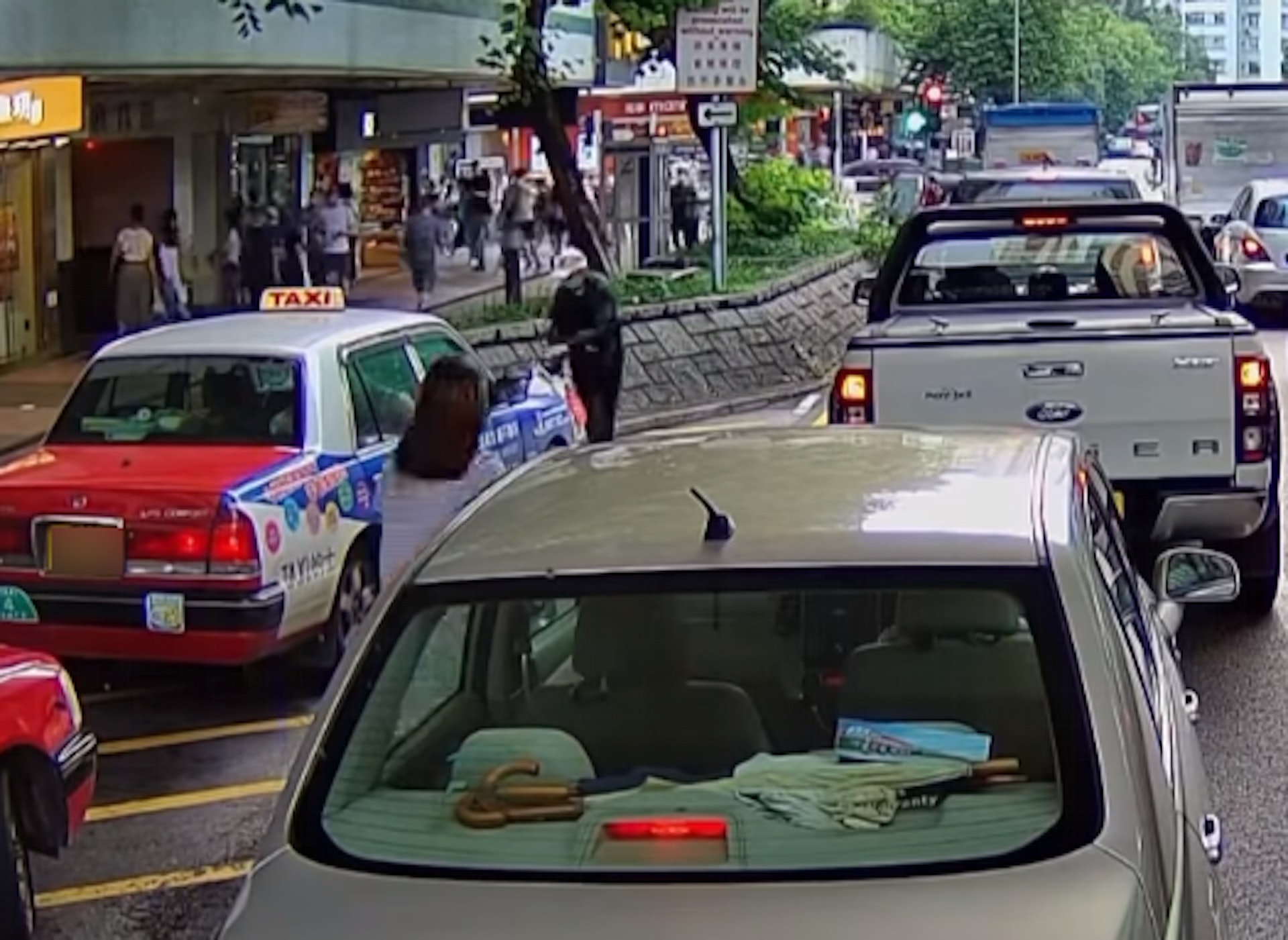 這時1輛私家車駛至避車處旁,沿車流停下等待轉燈,坐在副駕位置的女子留意到伯伯的情況,即時落車走近。(fb「大埔人大埔谷」影片截圖) 這時1輛私家車駛至避車處旁,沿車流停下等待轉燈,坐在副駕位置的女子留意到伯伯的情況,即時落車走近。(fb「大埔人大埔谷」影片截圖)