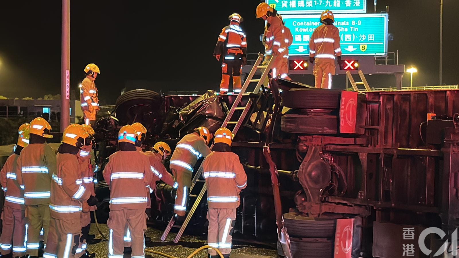 消防員攀梯救出困貨車司機。（黃江奇攝）
