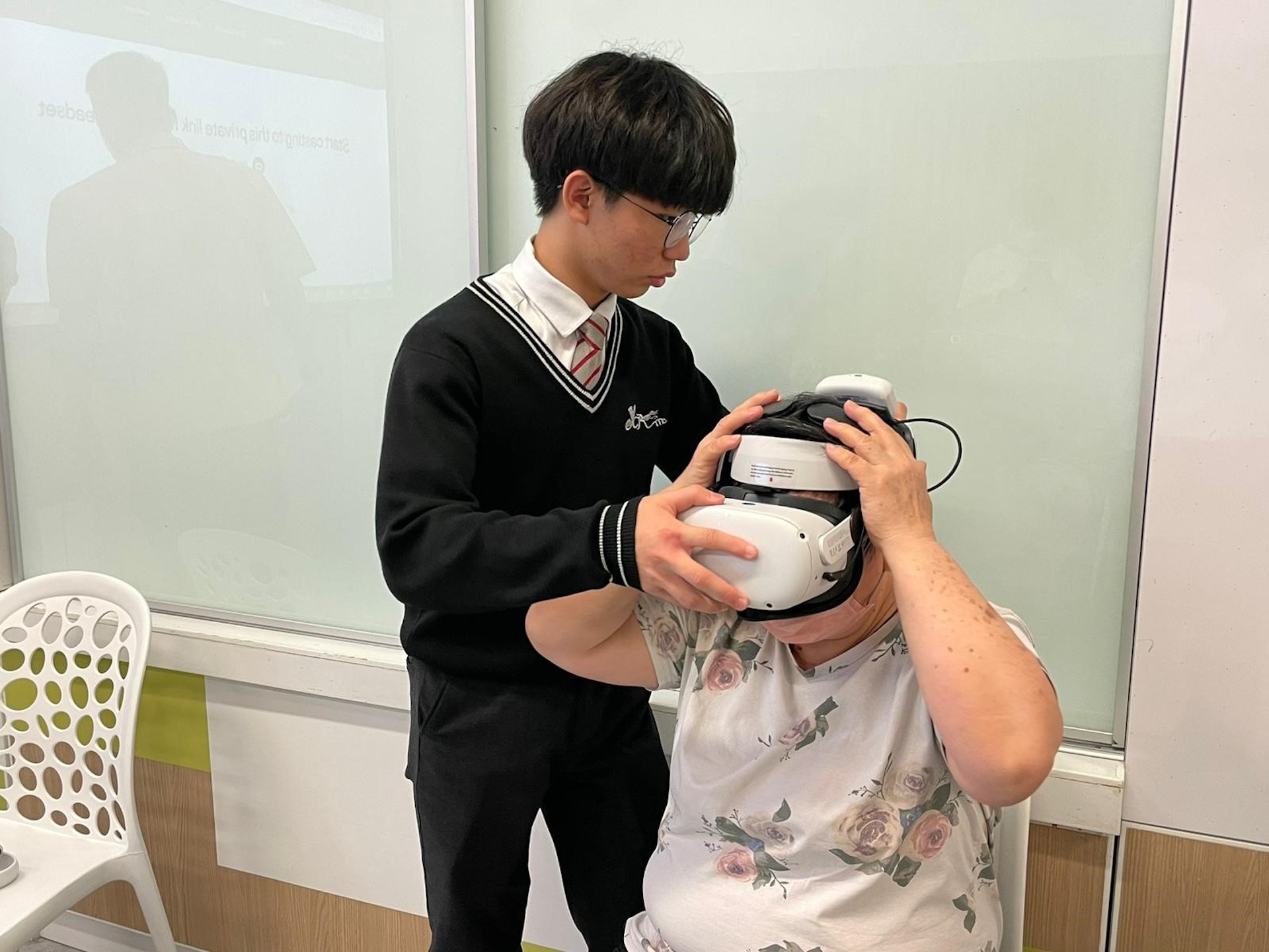 鄭燚塱同學耐心為長者戴上VR裝置。(余振強紀念中學提供) 鄭燚塱同學耐心為長者戴上VR裝置。(余振強紀念中學提供)