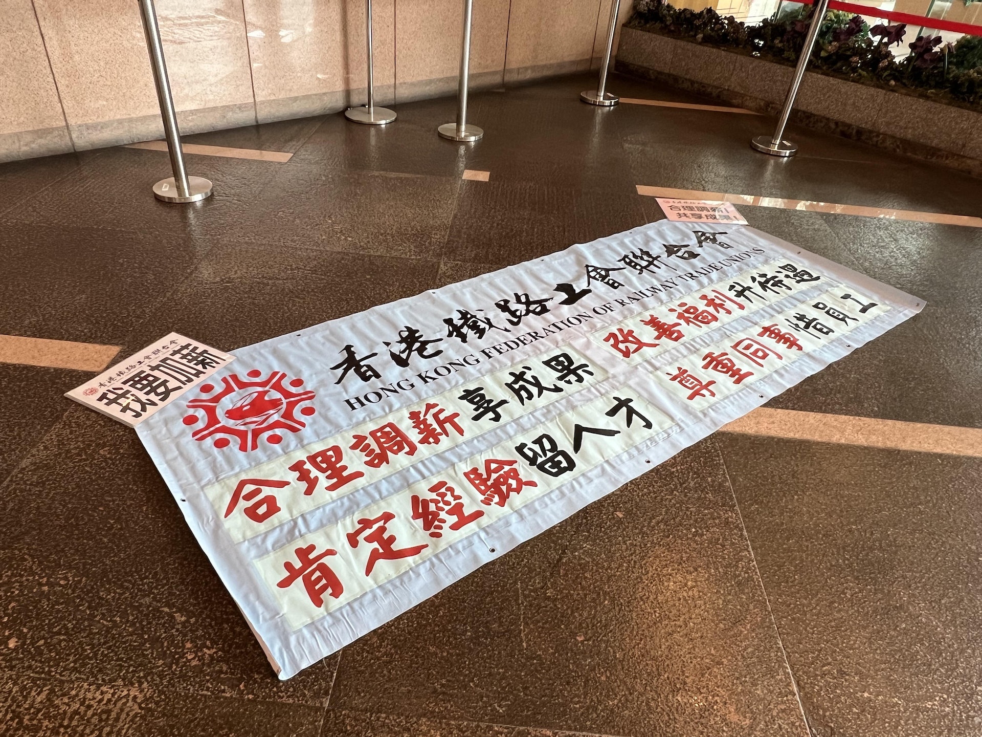 7月5日,港鐵與工會開會商討薪酬調整方案,工會在大堂展示橫額要求加薪。(何瑞芬攝) 7月5日,港鐵與工會開會商討薪酬調整方案,工會在大堂展示橫額要求加薪。(何瑞芬攝)