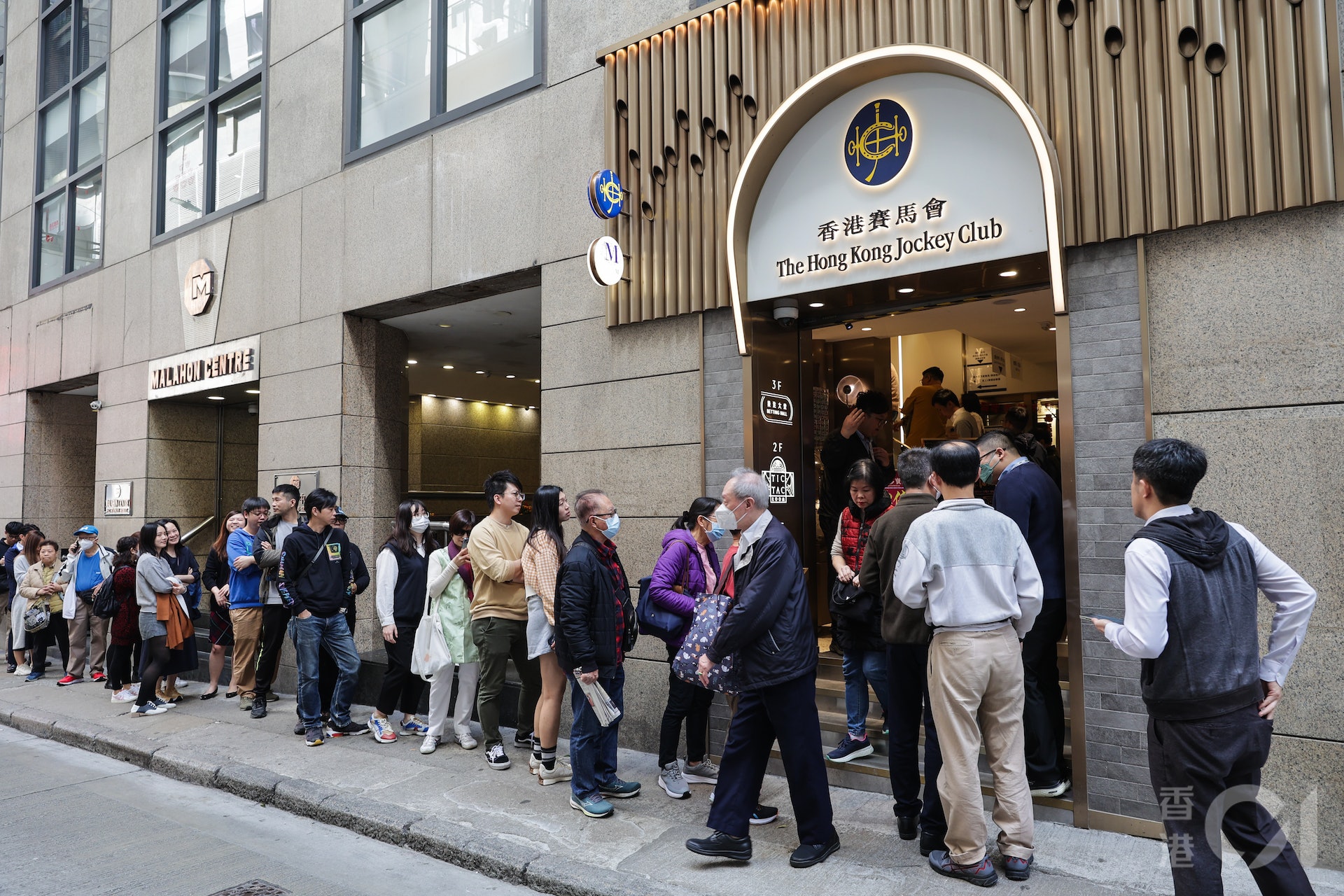 頭獎1.18億元的六合彩新春金多寶2月14日情人節晚攪珠,在最旺的中環士丹利街投注站,中午時分有長長人龍排隊買彩票。(蘇煒然攝) 頭獎1.18億元的六合彩新春金多寶2月14日情人節晚攪珠,在最旺的中環士丹利街投注站,中午時分有長長人龍排隊買彩票。(蘇煒然攝)