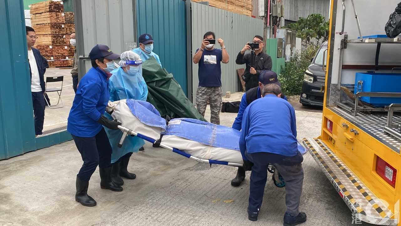 死者遺體由仵工舁送殮房。（羅日昇攝）