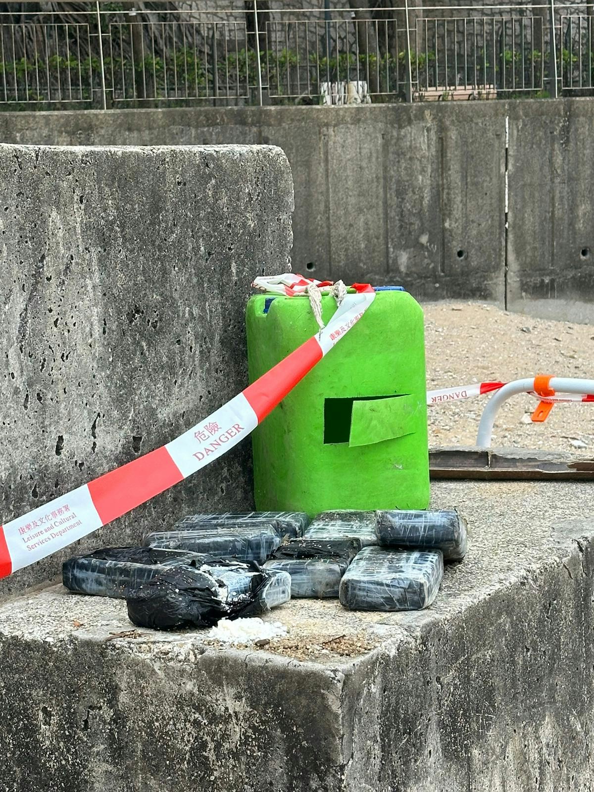 救生员在滩尾发现一个绿色胶桶，内藏至少8个砖状物体，其中一砖有破损，赫见有白色粉末。（读者提供）