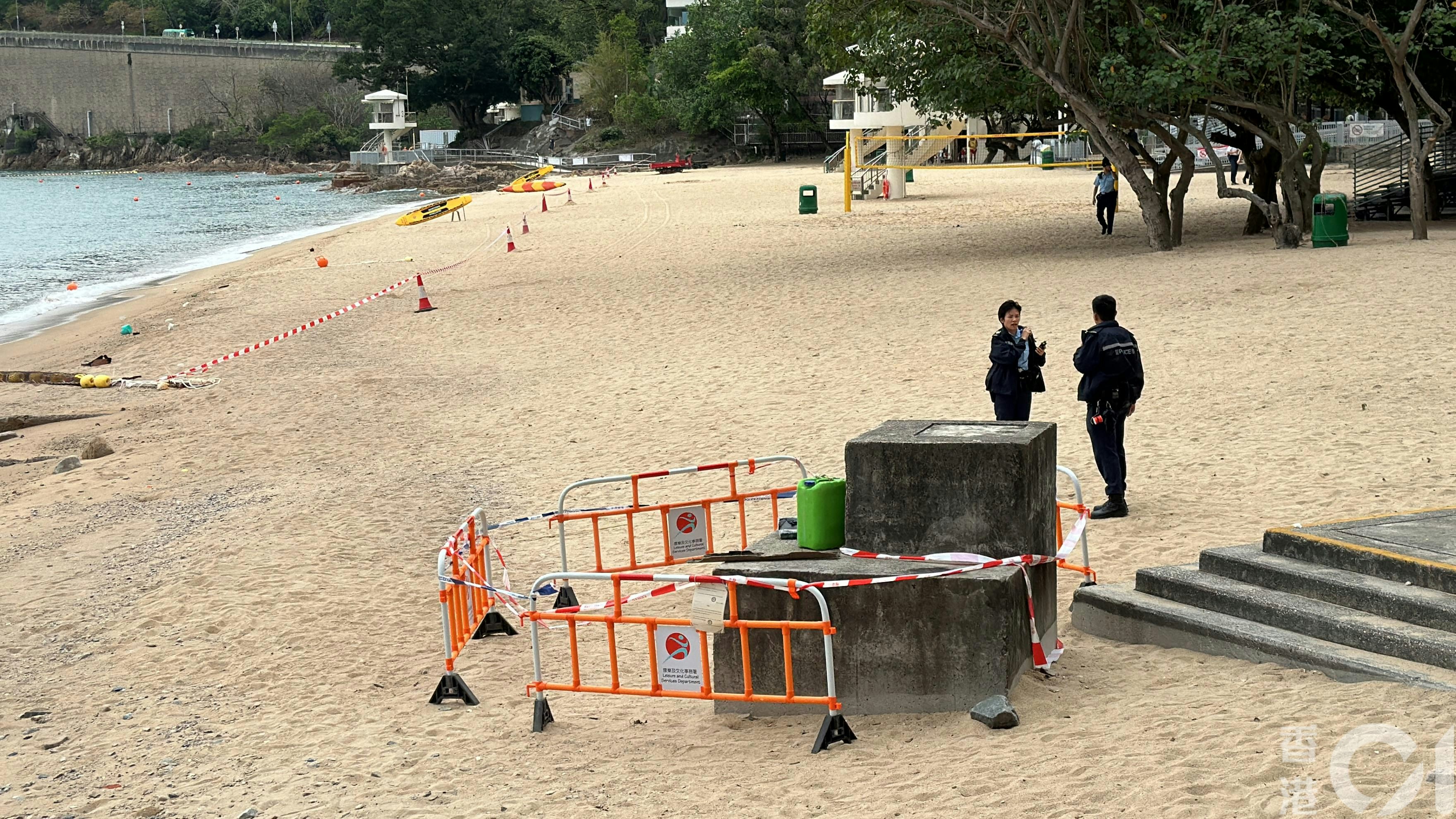丽都湾泳滩发现8砖可疑包裹，内藏白色粉末，警员接报到场调查。（马耀文摄）