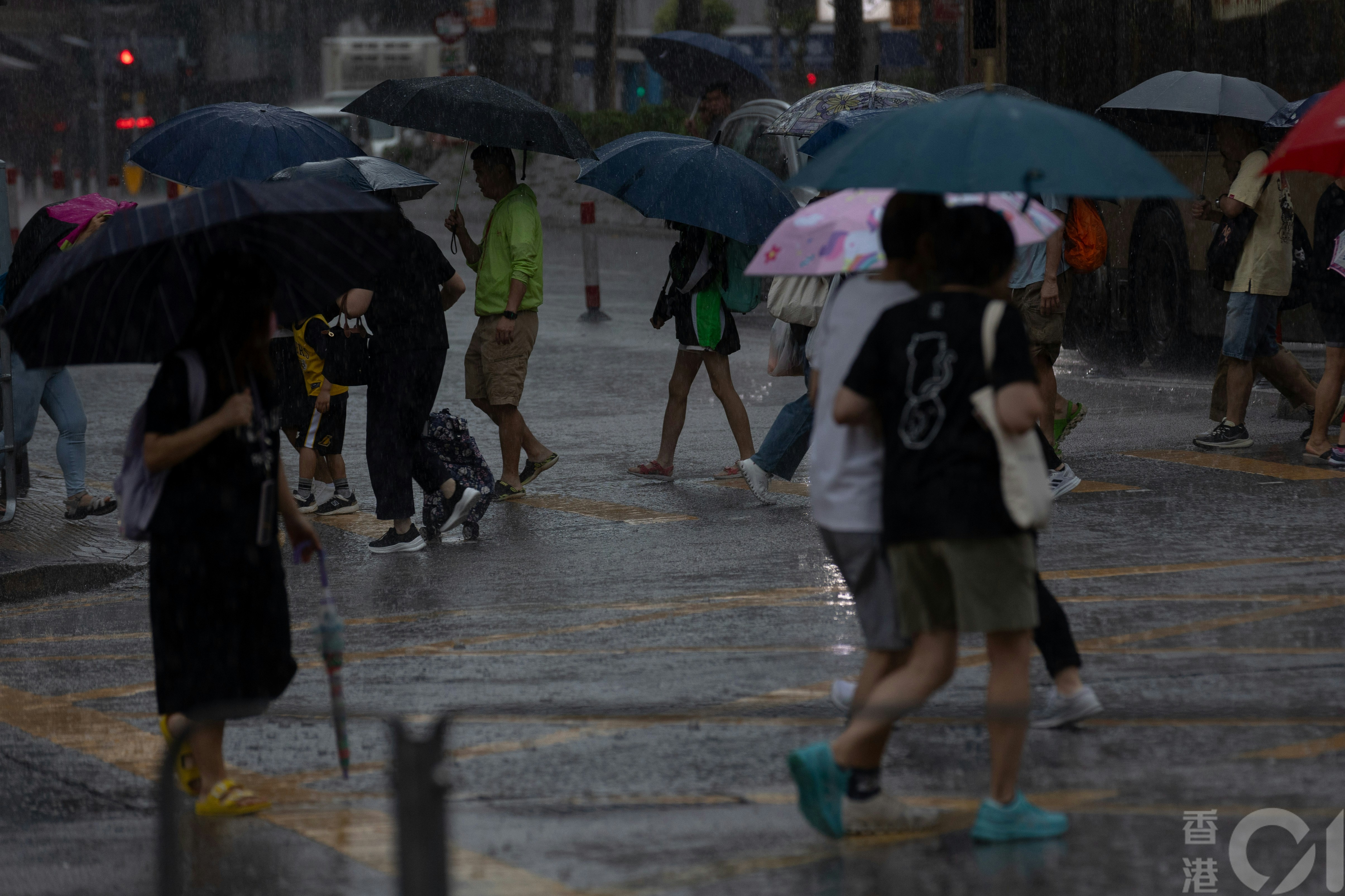 天文台4月21日早上发出黄色暴雨警告，在大埔，出街市民在风雨中而行。（夏家朗摄）
