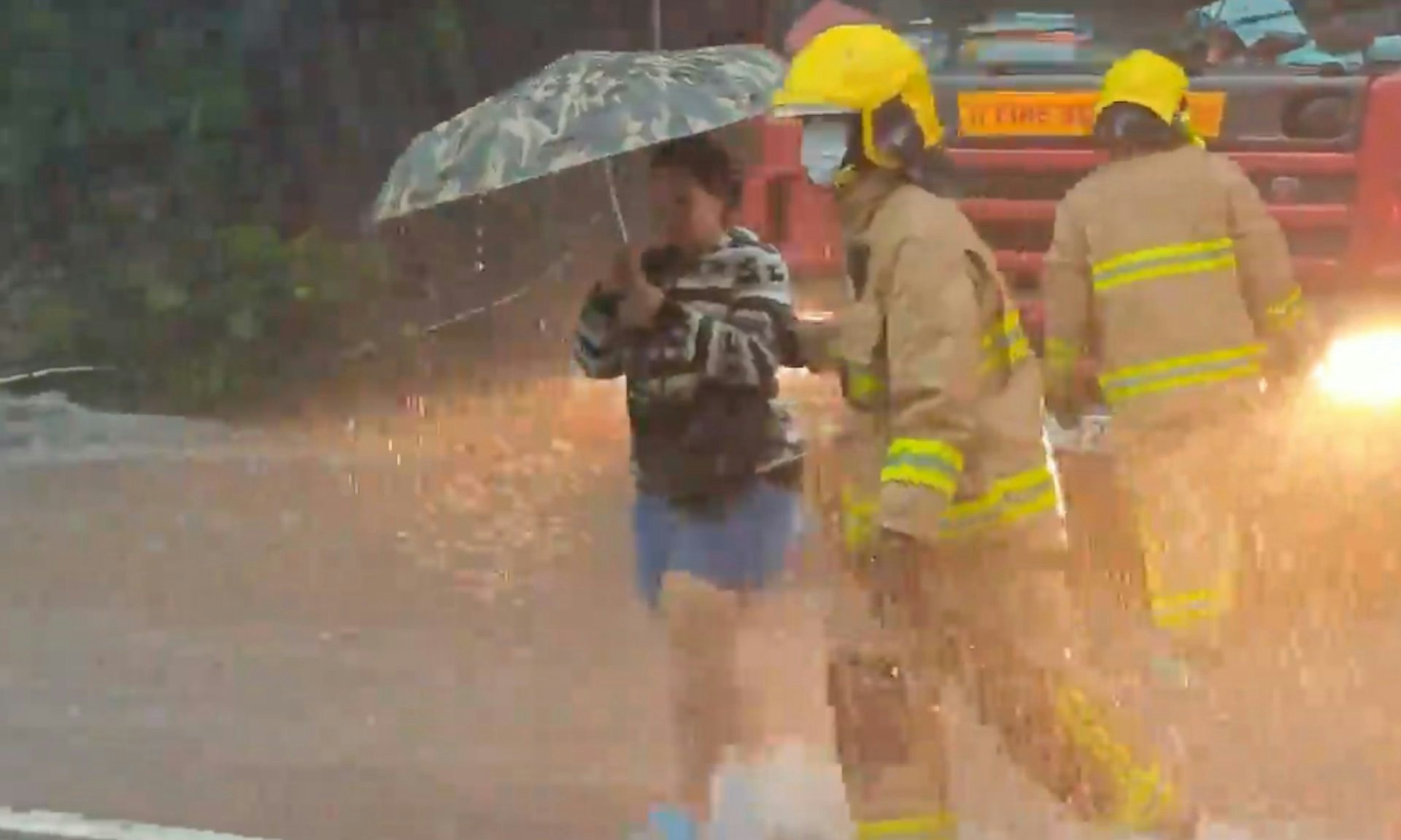 5月4日将军澳暴雨大水浸。消防员协助巿民涉水过马路。
