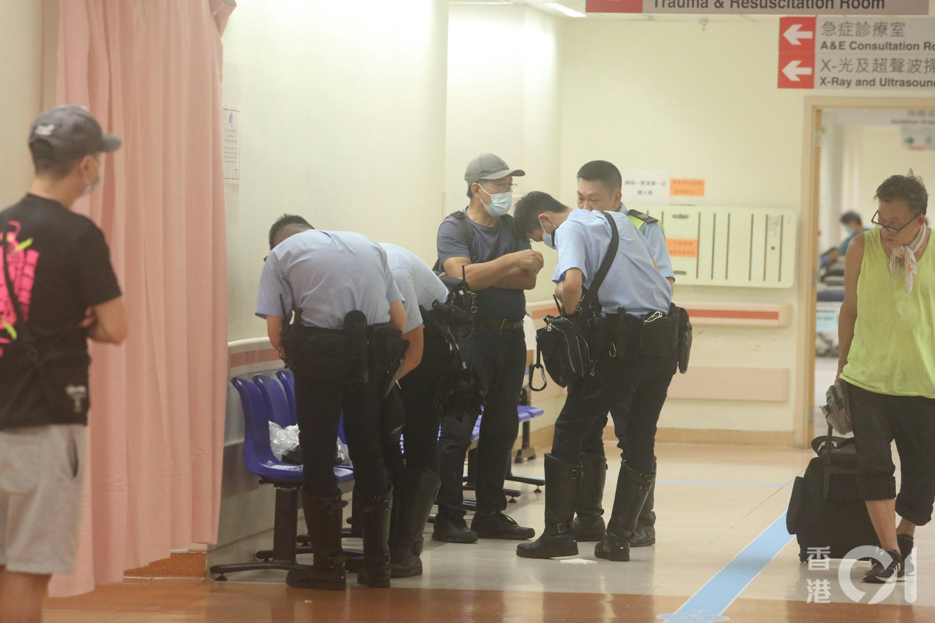 死者拍檔(戴帽者)趕抵醫院,悲慟不已。(林振華攝)