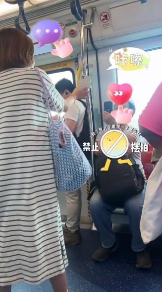 女子站了起來，與坐着的男子拿着手機互拍，女子大聲說「睇得到，睇得到，睇得好清楚呀」。（Threads影片截圖）