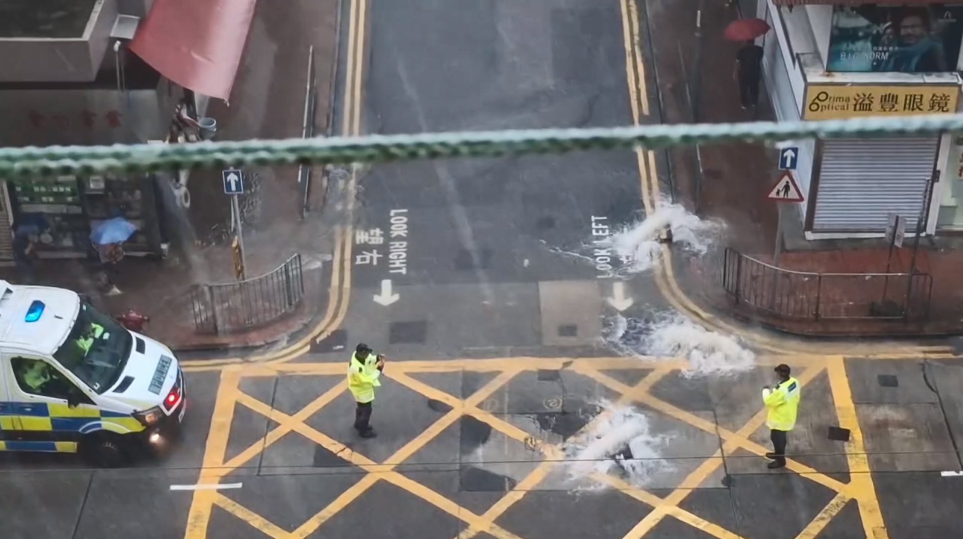 現場兩名警員站在馬路中央指揮交通,警車停泊在路邊戒備。(網民Mui Mui圖片)