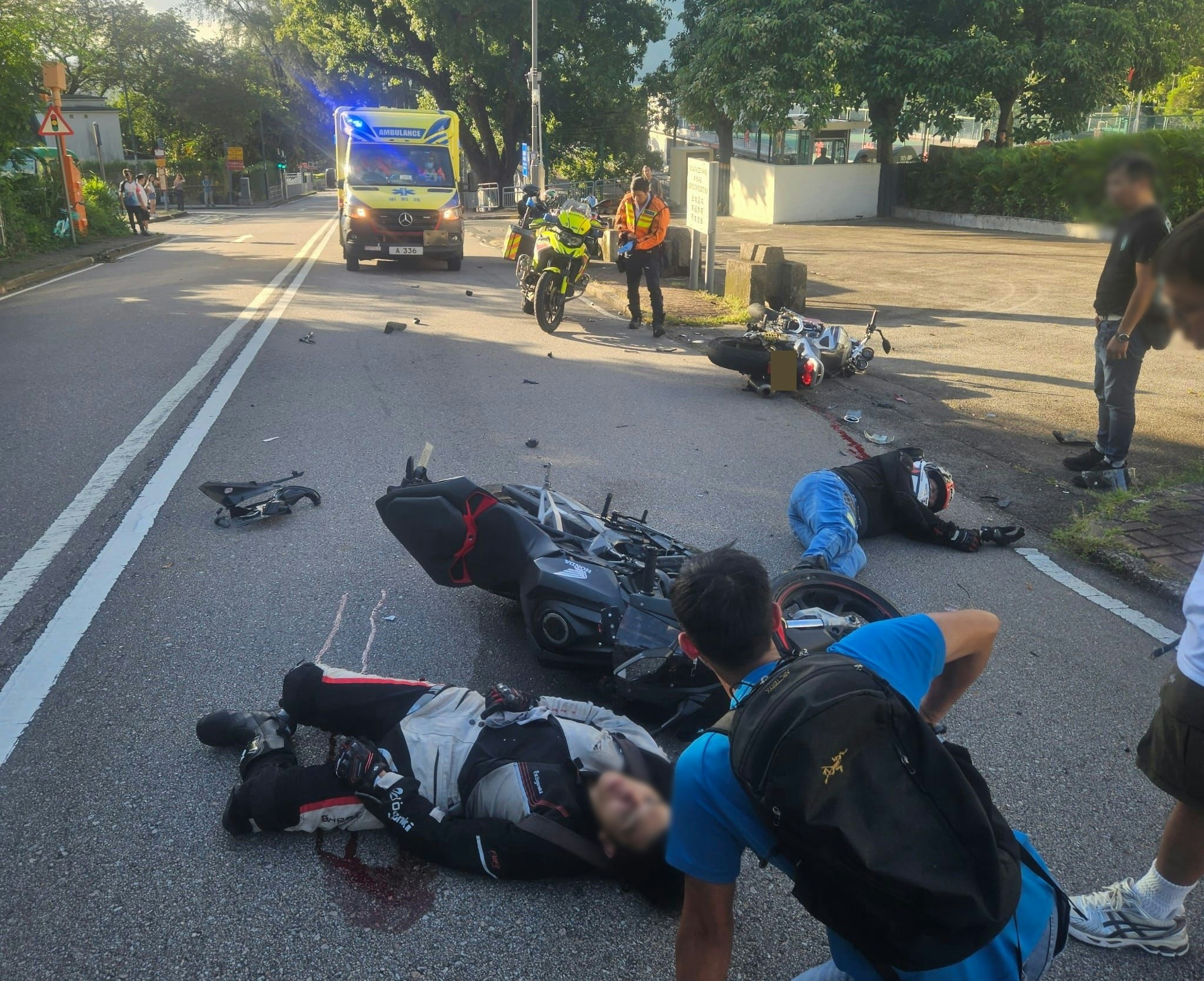 兩名傷者均受傷倒地，身旁遺有大灘血跡；兩輛涉事電單車損毀嚴重，零件等四散一地。（網上圖片）
