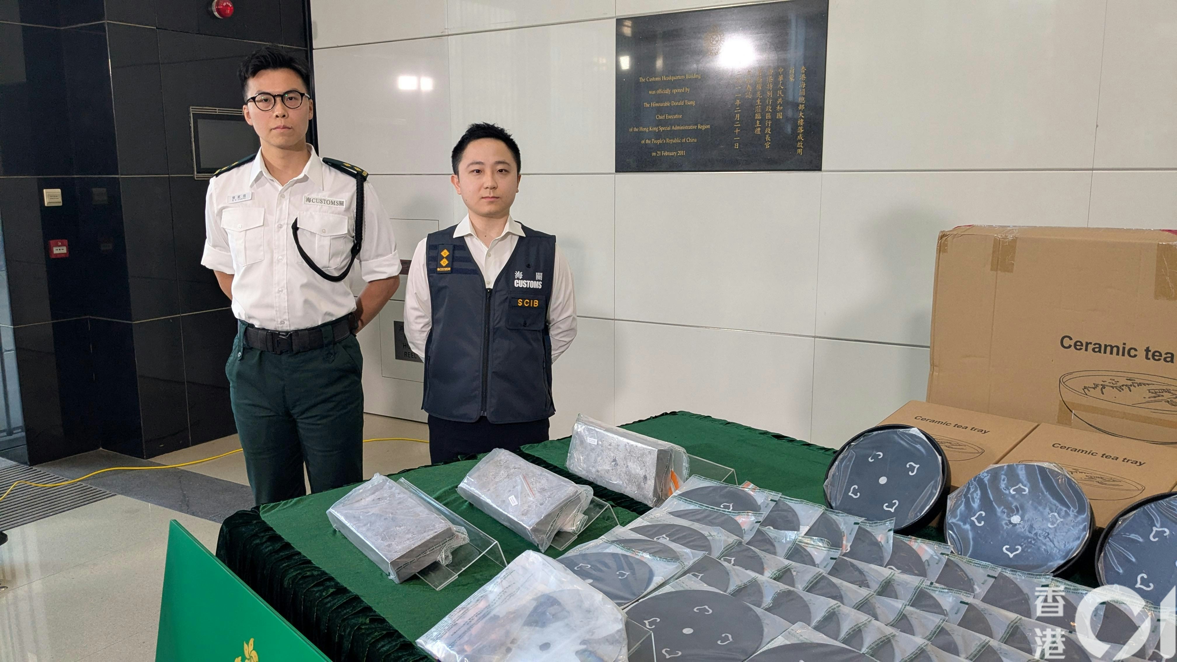 海關機場科空運貨物第一組督察曾家俊（左）及有組織罪案調查科特別調查第一組調查主任何廷俊（右）交代案件。 （黃偉民攝）