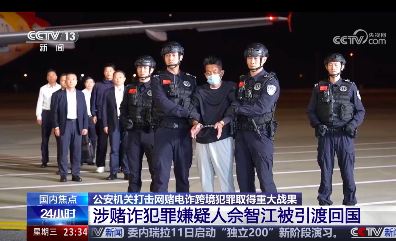 圖為2025年11月12日，載著佘智江的客機昨晚降落南京祿口國際機場，他隨即被警方鎖上手扣，押解落機及離開。（央視截圖）