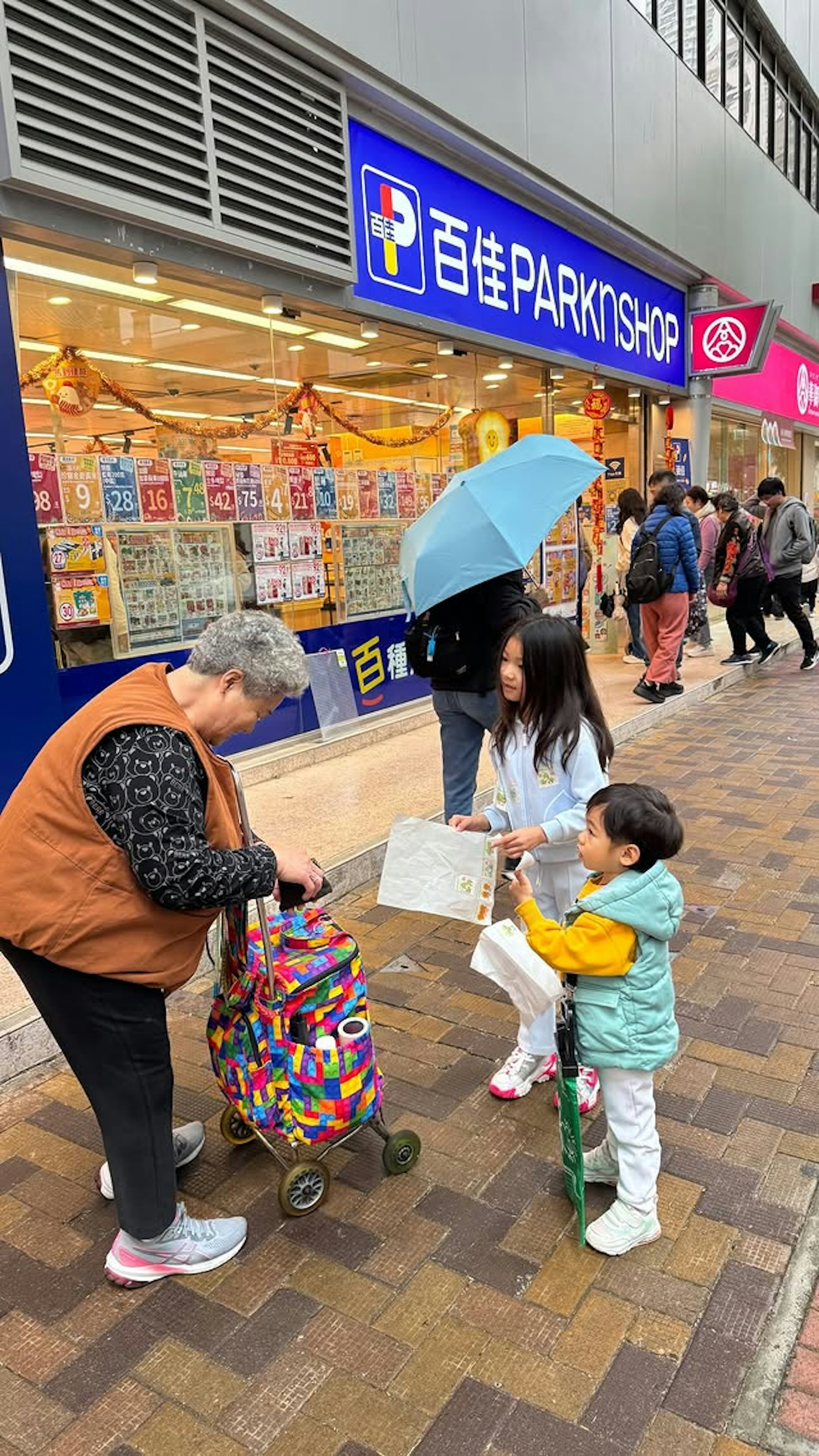 李美慧的一对仔女在超市门口卖旗。(IG截图)