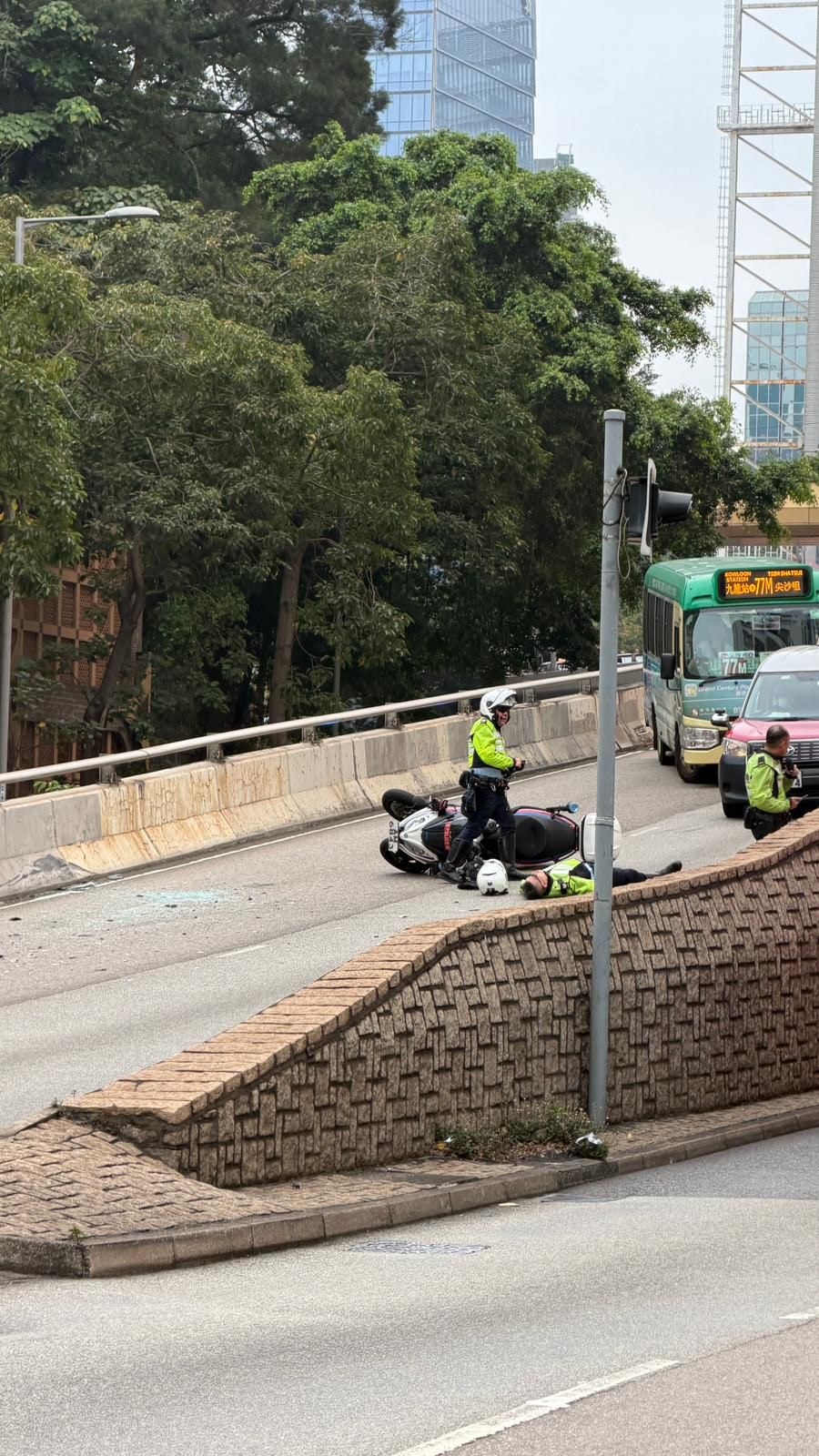 交通警仰天倒地,電單車翻倒一旁。(讀者提供)