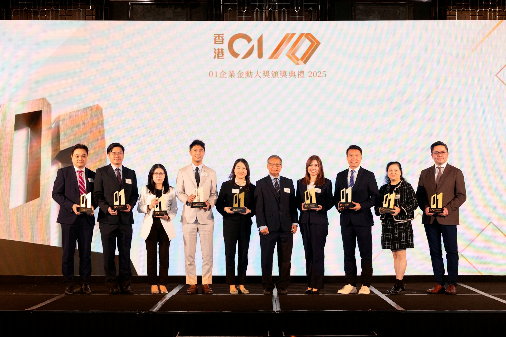 2026年3月20日,《香港01》舉辦第六屆「01企業金勳大獎」頒獎禮,得獎公司與評審一同合照。(《香港01》圖片)