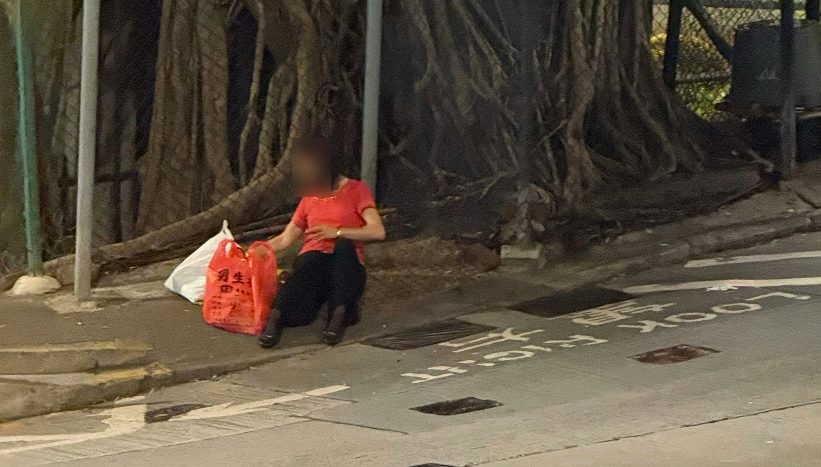 盂蘭節紅衣女子高街鬼屋外燒衣 竟將火燼拋入渠道惹眾怒