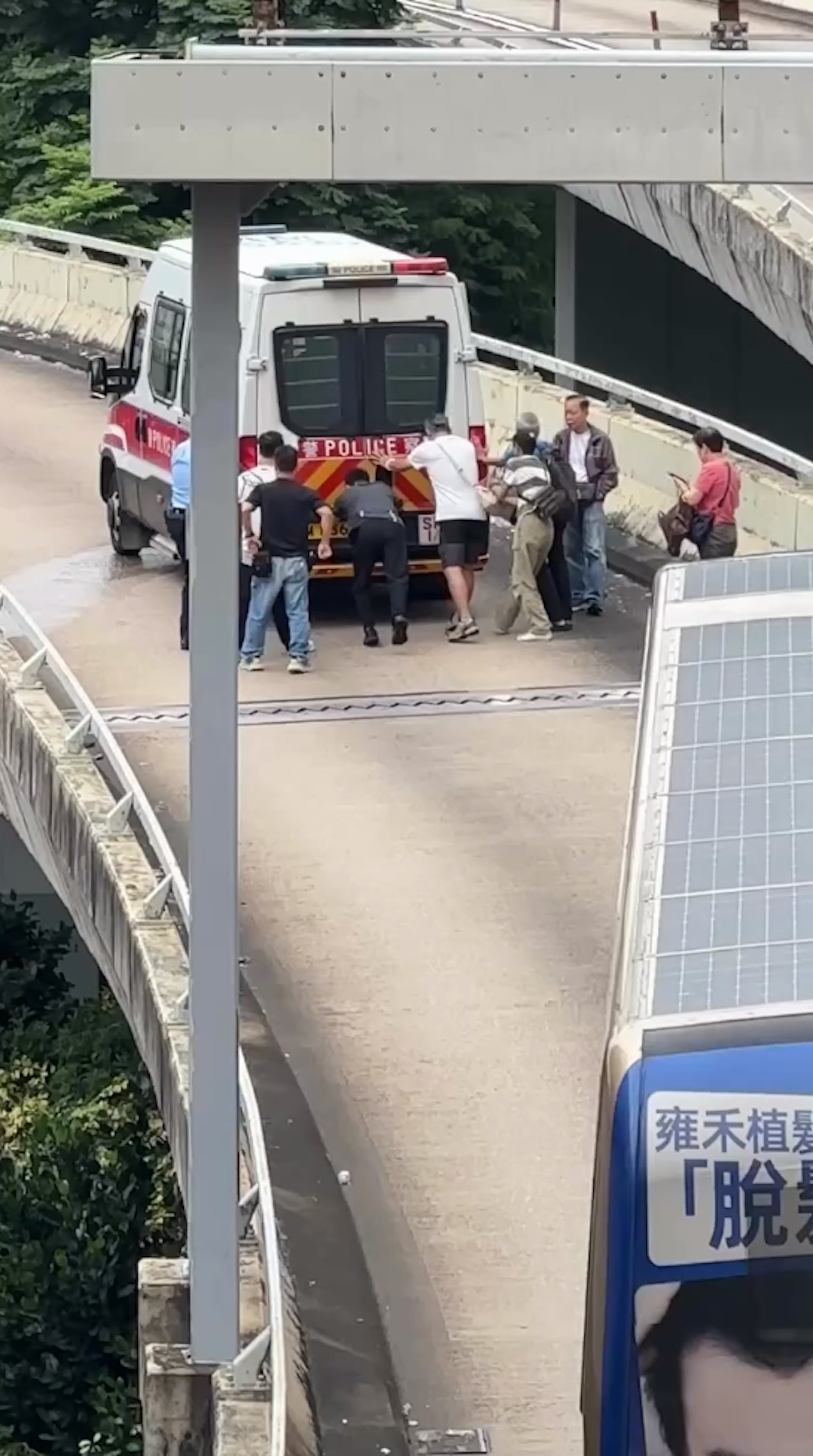一輛警車於一條行車天橋「死火」,9人合力推車。(Facebook車cam L(香港群組)影片截圖)