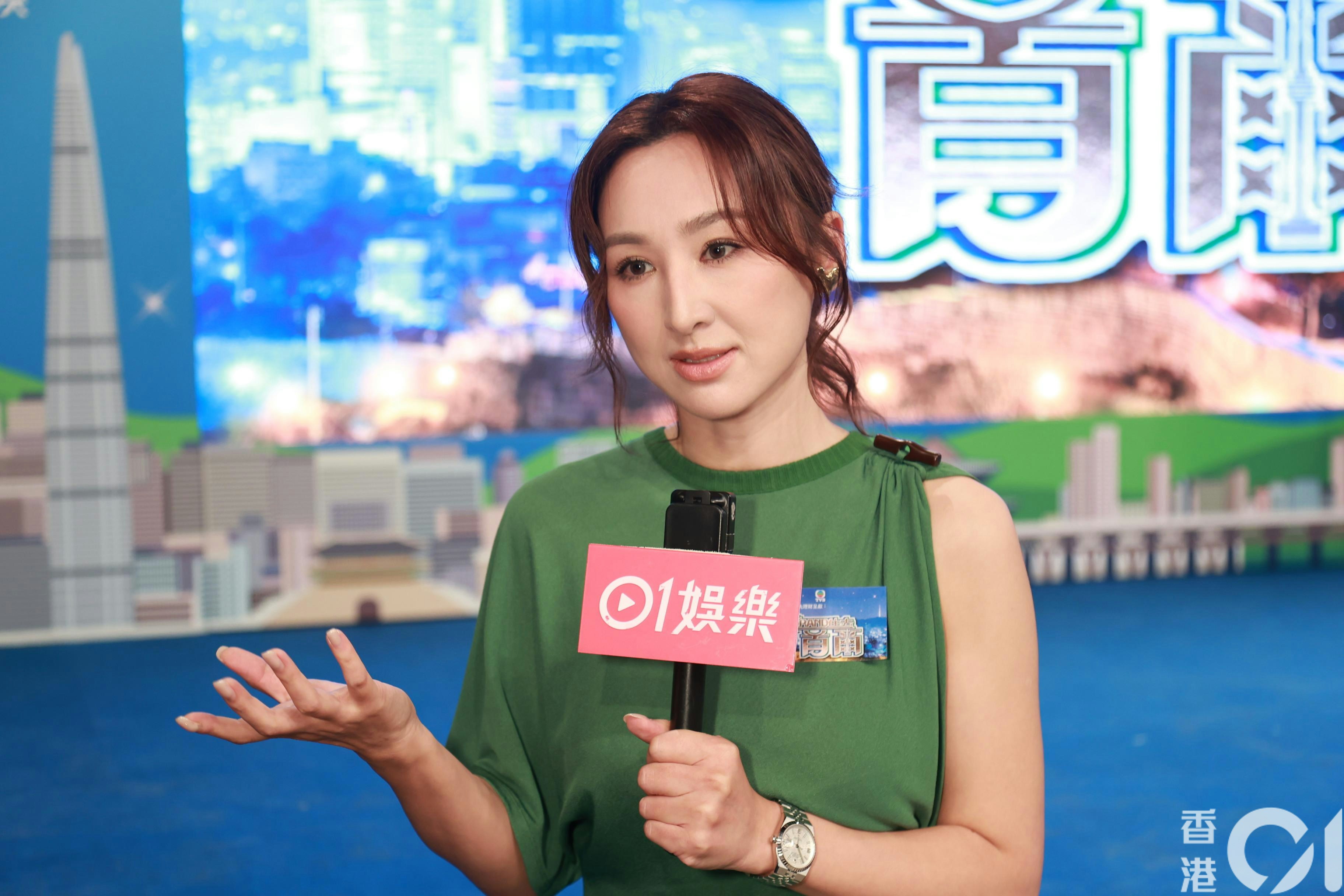 香港01の取材に応じる高海寧。緑色の衣装でマイクを手にしている